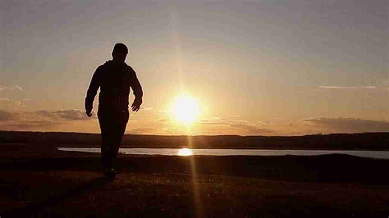 A Person Walking Towards A Sunset Over A Mountain Range Journey Of A Thousand Miles