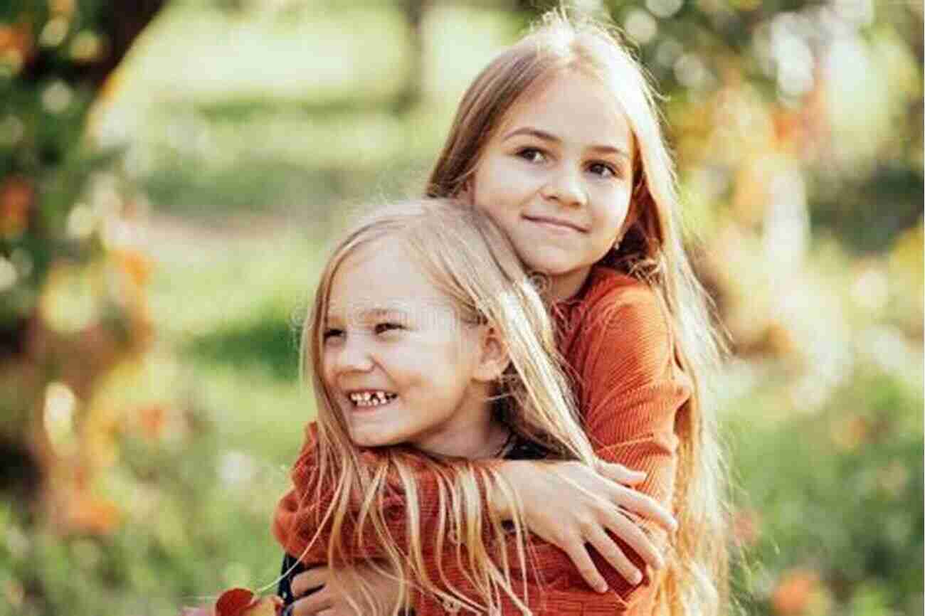 Two Happy Sisters Hugging Each Other And Laughing In A Sunny Garden What Happiness Looks Like (Sisters 2)